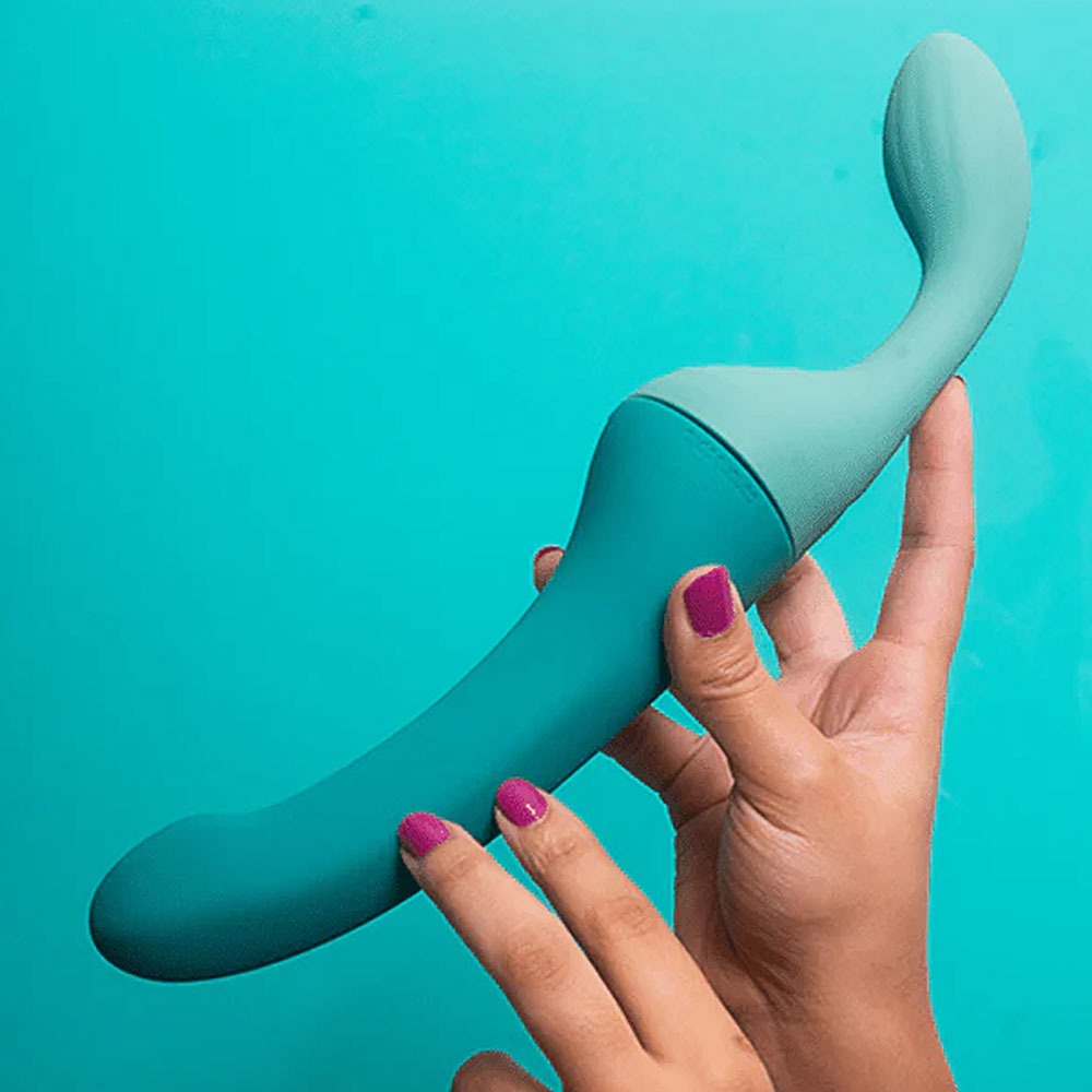 Banana Split customizable couples strapless strap on vibrator with dollop side, and attached banana side, connected held by 2 hands