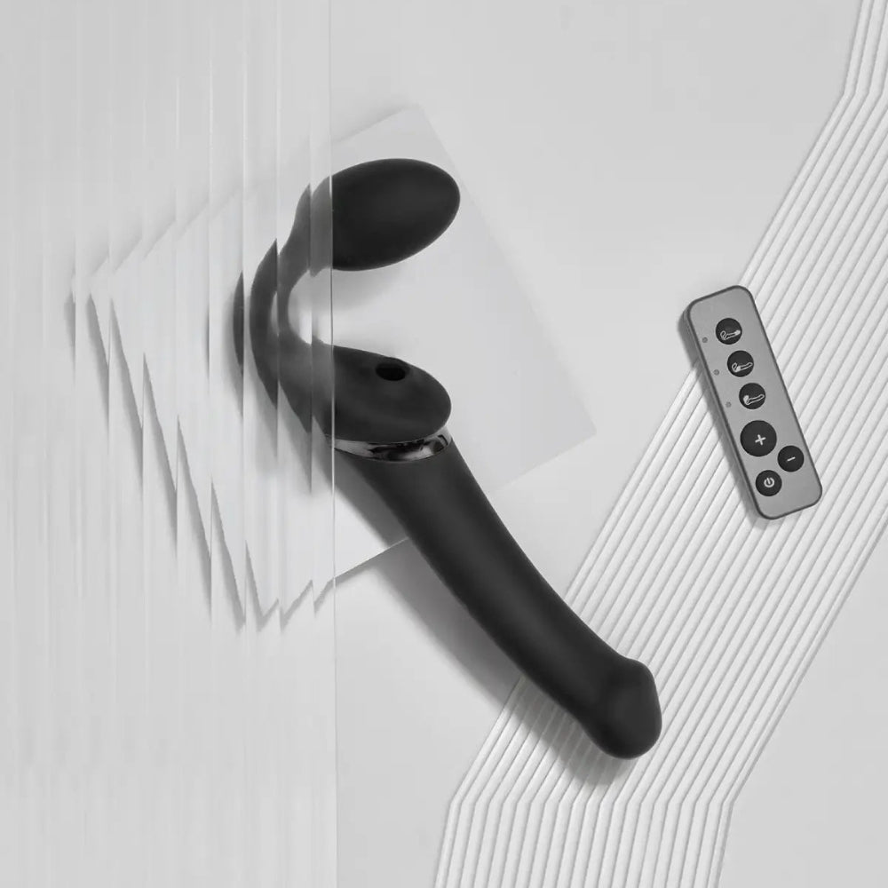 Strap on me multi orgasm strapless strap on vibrator in black in size large, from the side with wireless remote