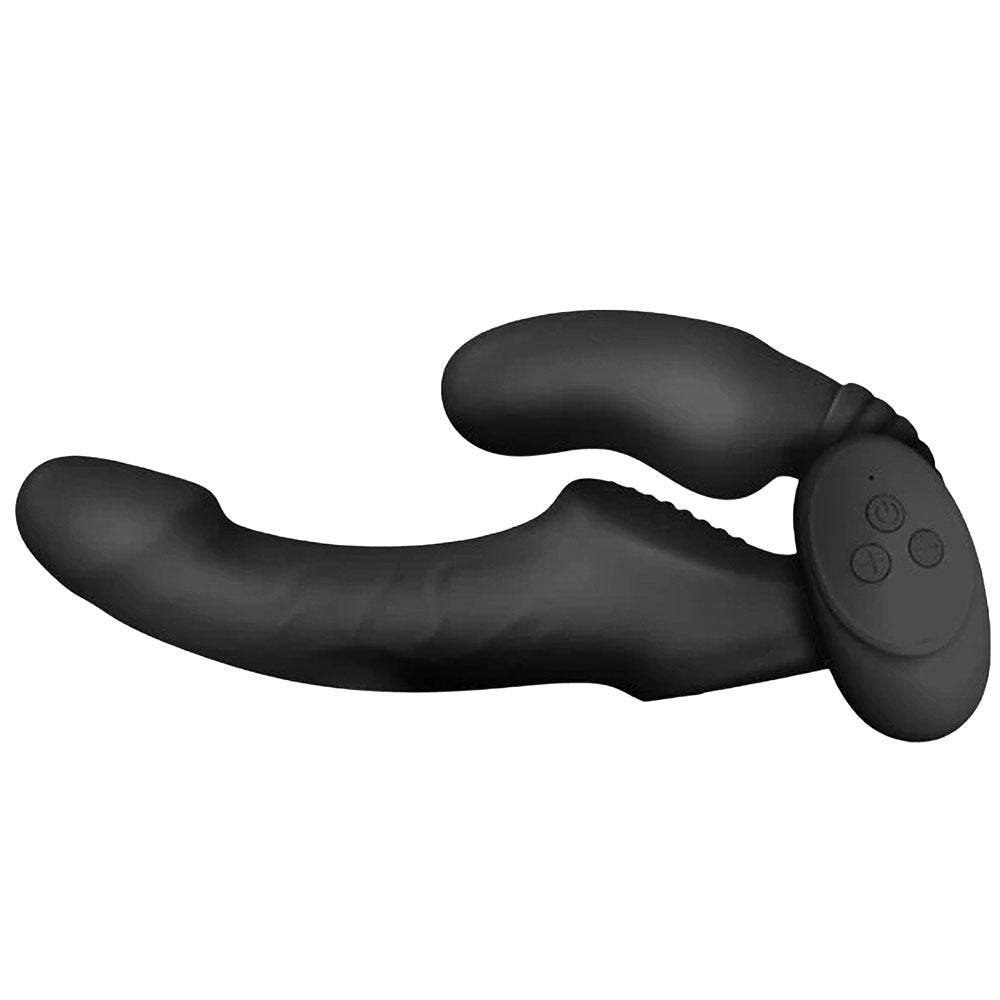 Nexus Vibes Together silicone vibrating strapless strap on double sided dildo in black, from the side, with its wireless remote laying against the wearer insert side