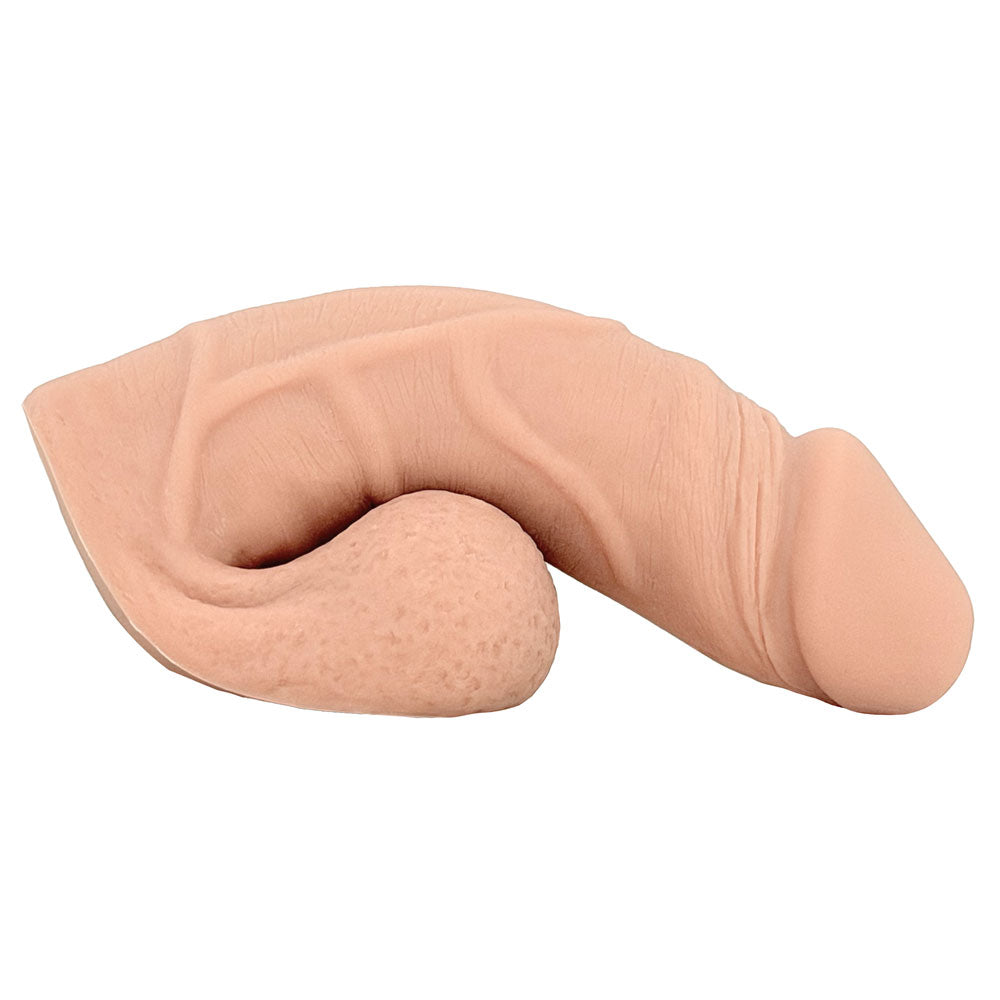Freeform Medium 5 inch silicone soft ftm packer, in vanilla color from the side, sitting on the balls as a base