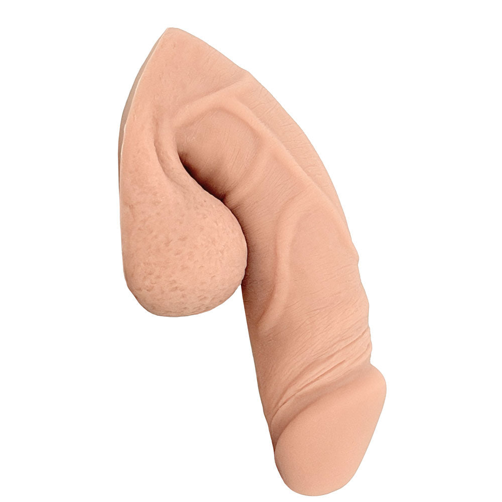 Freeform Medium 5 inch silicone soft ftm packer, in vanilla color from the side in the flaccid packed position