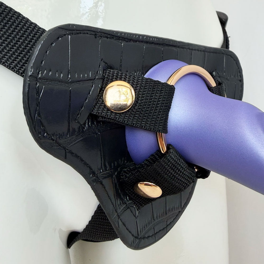 Nexus silicone fun and love harness and silicone dildo set, with purple tease inserted zoomed in to show the gold hardware