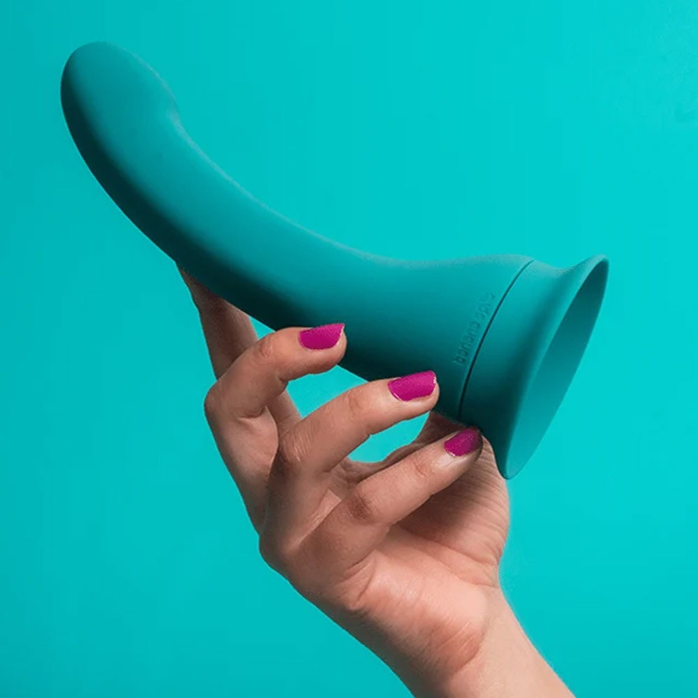 Banana vibrator in its stand alone form, held in a hand