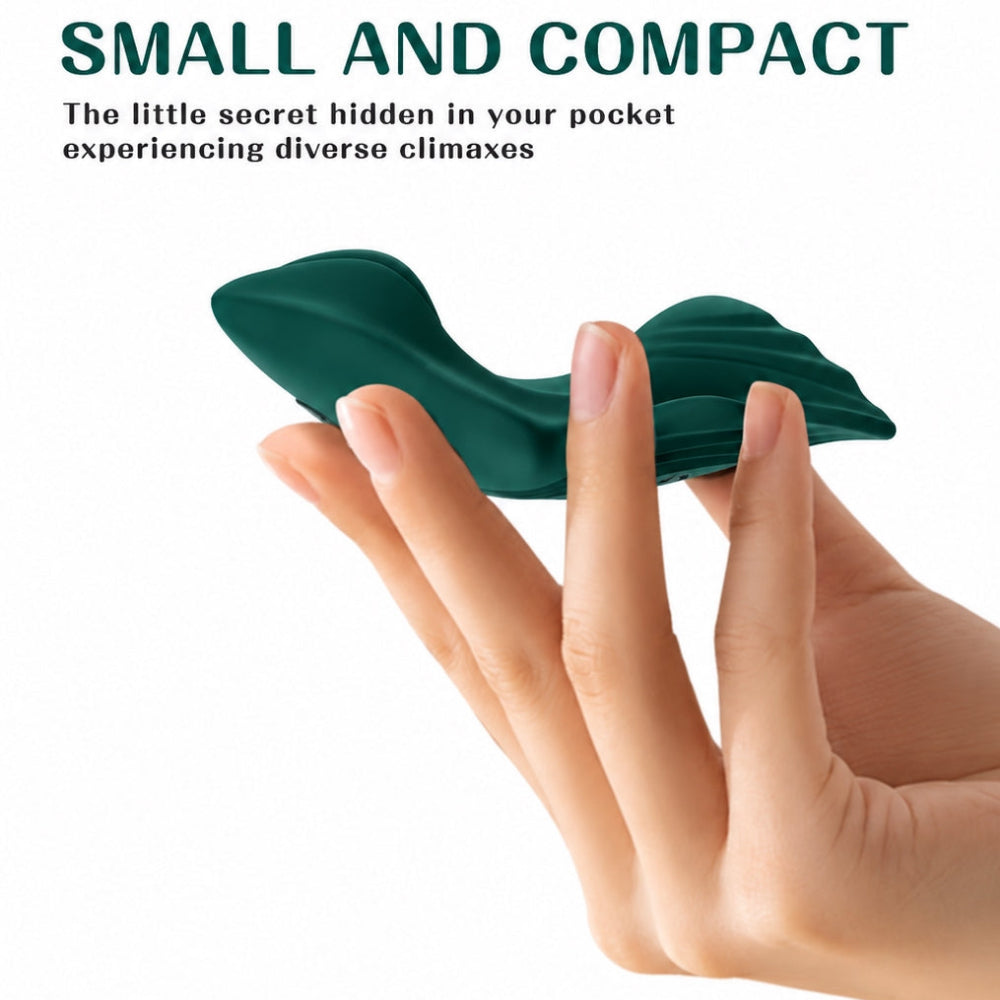 Green Flutter silicone rermote control panty vibe held in a hand for relative size
