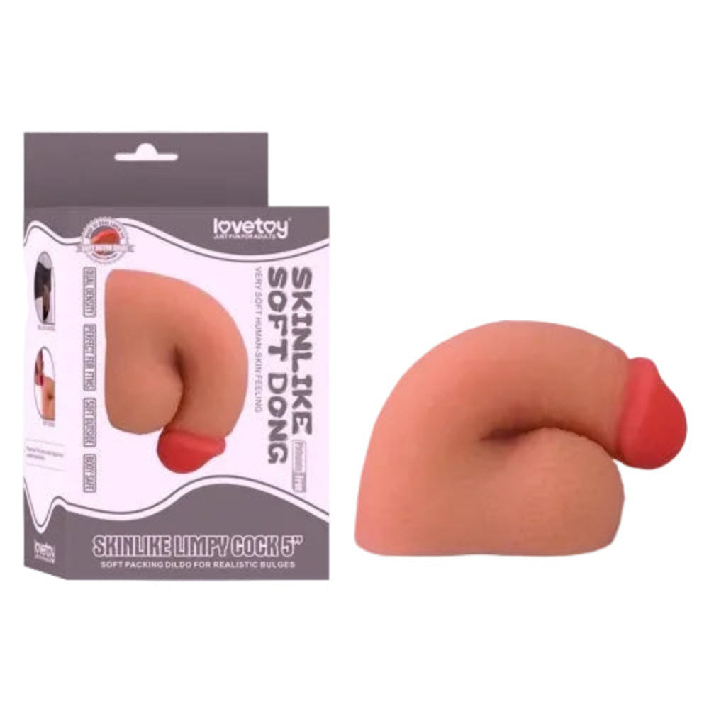 Love toy 5 inch dual layer TPE packing penis form the side in a flaccid position, next to its box