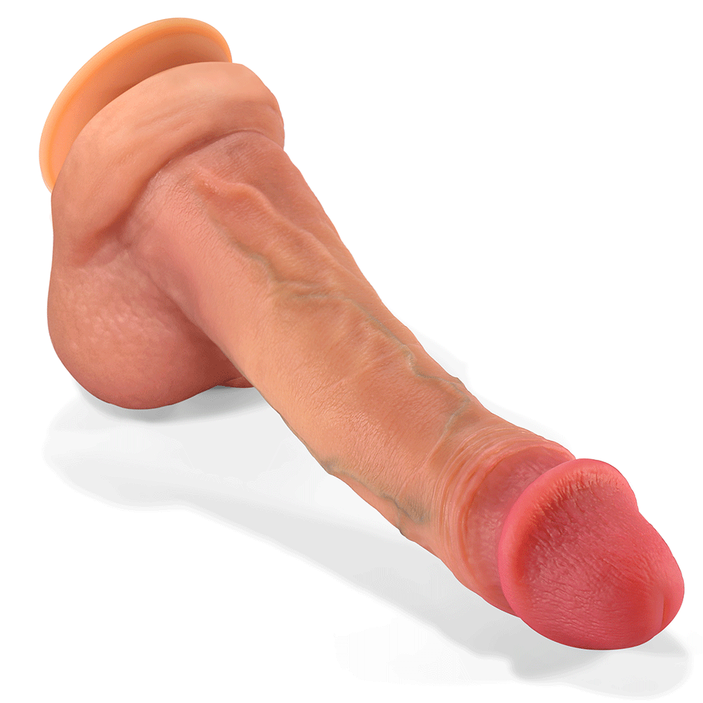 Nexus Silicone Dual Density Caramel colored Silicone Dildo with Floating Balls and realistic painted details , laying on its front with the tip to the right and downwards