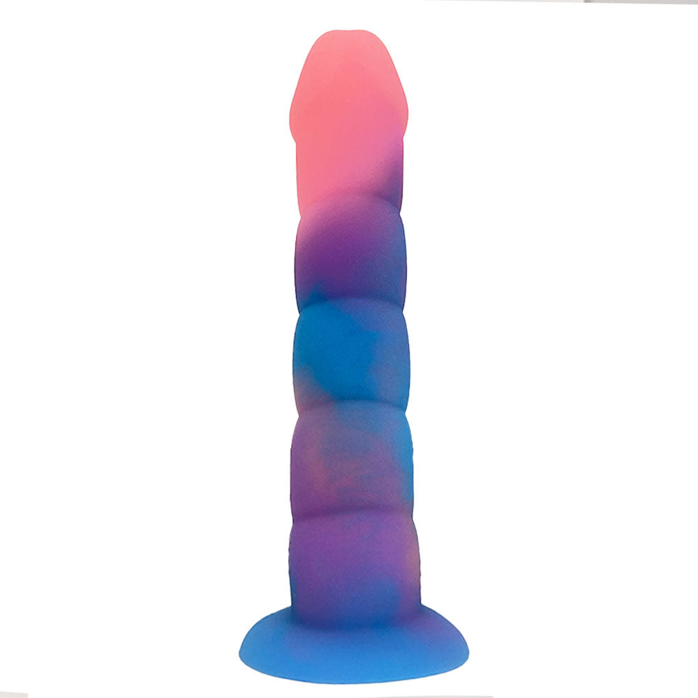Nexus Loli swirl ribbed silicone dildo in Aurora glow, a pink, blue and purple mix, flat on its suction base, from the back of the shaft