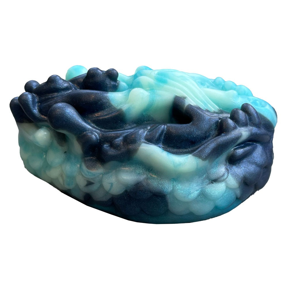 Pris Toys Tribble fantasy silicone dildo cushion with vibe hole from the side in Night tide, a blend of blues